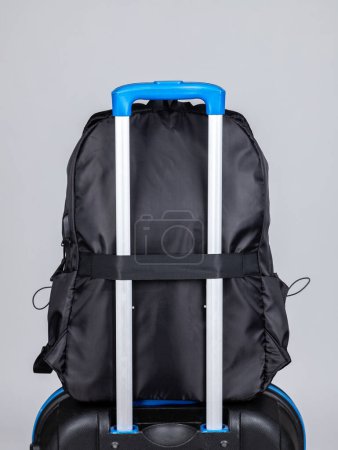 Photo for Close-up of a black men's backpack to put on the handle of a suitcase for easy travel - Royalty Free Image