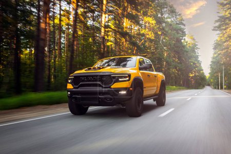 Photo for Novosibirsk, Russia - July 27, 2023:  yellow Dodge Ram Trx Havok Edition, pickup  driving  in  park, front view - Royalty Free Image