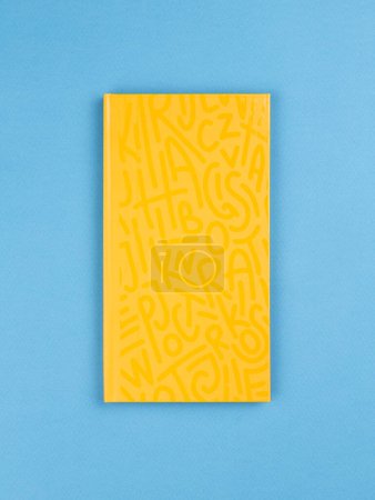 Photo for Yellow notepad on the table. Mockup on office copy space background. It is important not to forget the note - Royalty Free Image