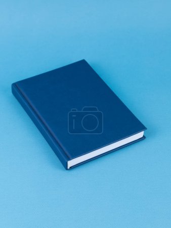 Photo for Blue notepad on the table. Mockup on office copy space background. It is important not to forget the note - Royalty Free Image