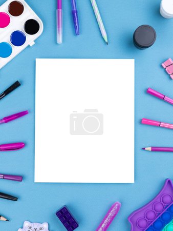 Photo for Top view arrangement album with white sheets and pens, pencils, paper clips and other office supplies on blue background - Royalty Free Image