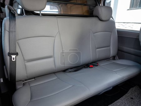 Foto de Novosibirsk, Rusia - 11 de septiembre de 2023: Hyundai Grand Starex, primer plano de los asientos traseros grises con cinturón de seguridad. interio coche moderno - Imagen libre de derechos