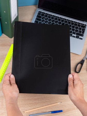 Photo for Close up of the  folder , a notebook,    on a wooden  table are ready for the lesson. Stationery.Back to school - Royalty Free Image