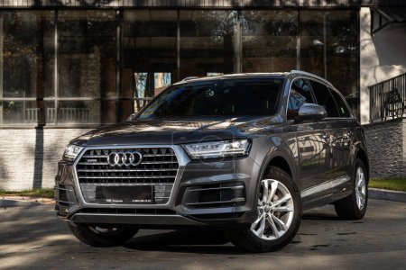 Photo for Novosibirsk, Russia -  October 11  , 2023: gray Audi Q7  parked on the street on a warm autumn day against the backdrop of   building - Royalty Free Image