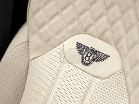 Photo for Novosibirsk, Russia -  November 03  , 2023: Bentley Bentayga ,   close-up  white  headrest driver's seat made of genuine leather with  logo - Royalty Free Image