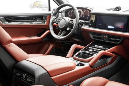 Photo for Interior of new modern SUV car with steering wheel, shift lever and dashboard, climate control, speedometer, display.  Red leather interior - Royalty Free Image