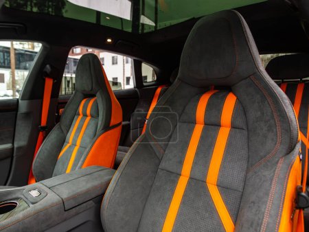 Photo for Novosibirsk, Russia -  December 21 , 2023:  Zeekr 001,Close-up  black and orange rear seat , in the background passenger seats with seat belts. Luxury car interior - Royalty Free Image
