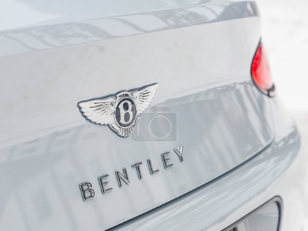 Photo for Novosibirsk, Russia - January  05 , 2024:  white Bentley Continental GT ,   close-up of the logo Bentley    on white car. - Royalty Free Image