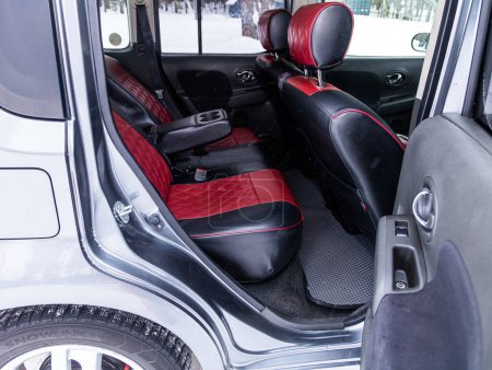 Photo for Novosibirsk, Russia - January  15 , 2024: silver Nissan Cube,  black and red  leather interior design, car passenger and driver seats with seats belt. - Royalty Free Image