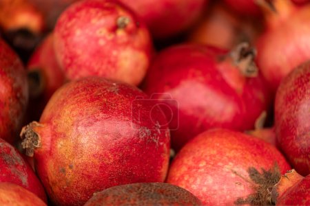 Photo for Close-up of bright fruits for background, texture. Red ripe pomegranates on display. - Royalty Free Image