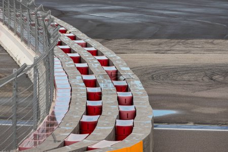 Photo for Asphalt red and white kerb of a race track detail. Motorsports racing circuit close up. - Royalty Free Image