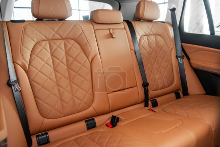 Orange  leather interior design, car passenger and driver seats with seats belt. 