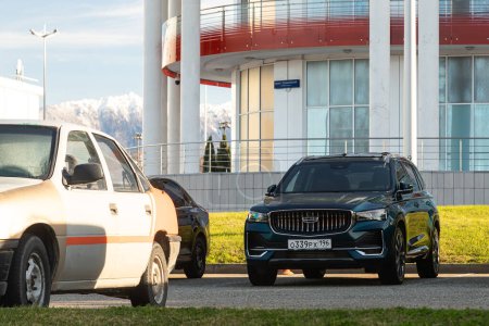 Photo for Sochi , Russia   January   01 2024:   gray Geely Monjaro   parked on the street on a warm  day against the backdrop of  city - Royalty Free Image