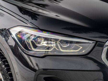 Photo for Novosibirsk, Russia - February  29 , 2024:  BMW X5, close up of the of  black  car with clear light headlight, bumper,  foglights - Royalty Free Image