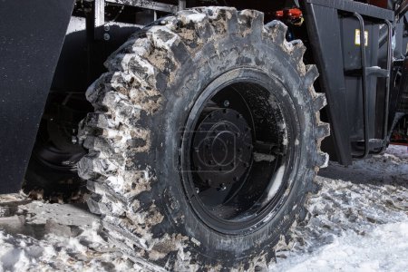 Photo for Novosibirsk, Russia - February  29 , 2024:    Orange tractor,  close-up car wheel   and new tires - Royalty Free Image