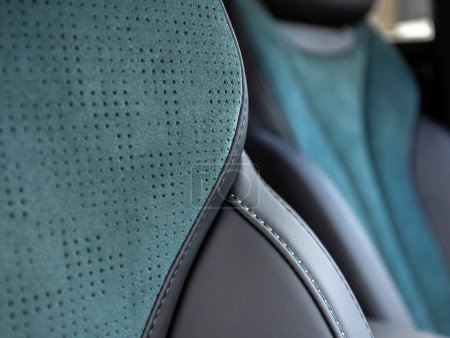 Part of leather car headrest seat details. lose-up black perforated leather car seat. Skin texture 