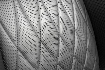 Part of leather car headrest seat details. lose-up black perforated leather car seat. Skin texture 