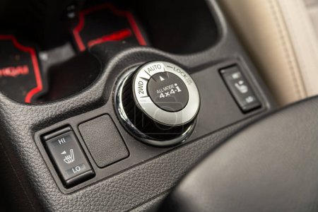 Novosibirsk, Russia -  April 04 , 2024:  Nissan Qashqai,  Close up 2WD, AUTO, LOCK  button switches control for car 