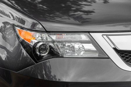 Photo for Novosibirsk, Russia - April  01, 2024:  gray  Acura MDX,  close up of the of   gray car with clear light headlight, bumper,  foglights - Royalty Free Image