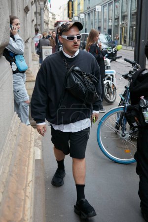 Photo for MILAN, ITALY - SEPTEMBER 21, 2022: Man with black sweatshirt and shorts before Calcaterra fashion show, Milan Fashion Week street style - Royalty Free Image