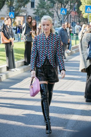 Photo for MILAN, ITALY - SEPTEMBER 22, 2022: Woman with black leather shorts and black patent leather boots before Emporio Armani fashion show, Milan Fashion Week street style - Royalty Free Image