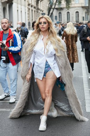 Téléchargez les photos : MILAN, ITALY - SEPTEMBER 25, 2022: Woman with beige fur coat and white shirt before Giorgio Armani fashion show, Milan Fashion Week street style - en image libre de droit