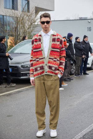 Photo for MILAN, ITALY - JANUARY 15, 2023: Man with beige trousers and wool sweater with geometric design before Etro fashion show, Milan Fashion Week street style - Royalty Free Image