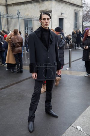 Photo for MILAN, ITALY - JANUARY 15, 2023: Man with black jacket with sheepskin collar and turleneck before Prada fashion show, Milan Fashion Week street style - Royalty Free Image