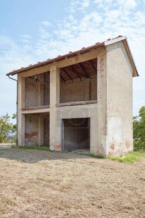 Photo for Old country hayloft with garage in a sunny day, blue sky in Italy - Royalty Free Image