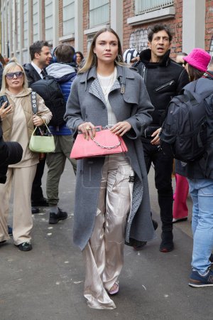 Foto de MILÁN, ITALIA - 22 DE FEBRERO DE 2023: Nina Suess con bolso Fedi de cuero rosa y abrigo gris antes del desfile de moda Fendi, Milan Fashion Week street style - Imagen libre de derechos