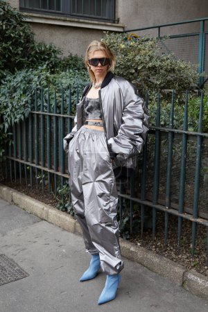 Photo for MILAN, ITALY - FEBRUARY 24, 2023: Woman with silver bomber jacket and trousers before Sportmax fashion show, Milan Fashion Week street style - Royalty Free Image