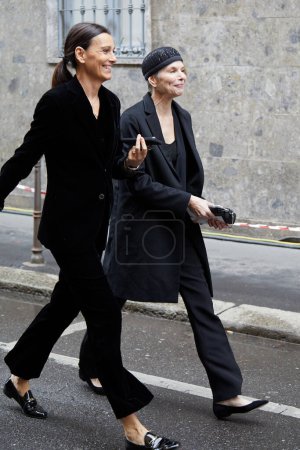 Photo for MILAN, ITALY - FEBRUARY 26, 2023: Women with black jacket and trousers before Giorgio Armani fashion show, Milan Fashion Week street style - Royalty Free Image
