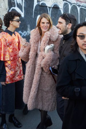 Foto de MILÁN, ITALIA - 12 DE ENERO DE 2024: Anna dello Russo con abrigo de piel rosa antiguo antes del desfile de moda de Gucci, Milan Fashion Week street styl - Imagen libre de derechos