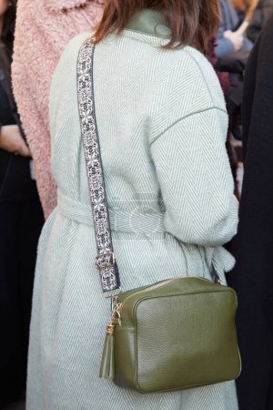 Téléchargez les photos : MILAN, ITALIE - 13 JANVIER 2024 : Femme avec sac en cuir vert olive avec bracelet en tissu avant le défilé MSGM, Milan Fashion Week street style - en image libre de droit