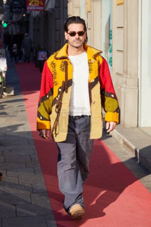 Photo for MILAN, ITALY - JANUARY 13, 2024: Giotto Calendoli with sunglasses and yellow and red jacket before MSGM fashion show, Milan Fashion Week street style - Royalty Free Image