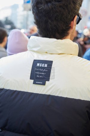 Photo for MILAN, ITALY - JANUARY 13, 2024: Man with MSGM white and blue puffer jacket before MSGM fashion show, Milan Fashion Week street style - Royalty Free Image