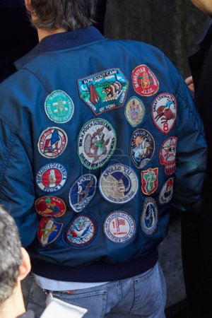 Photo for MILAN, ITALY - JANUARY 13, 2024: Man with blue bomber jacket with embroidery patches stickers  before MSGM fashion show, Milan Fashion Week street style - Royalty Free Image