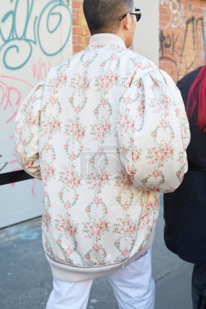 Photo for MILAN, ITALY - JANUARY 13, 2024: Man with white bomber jacket with floral decoration before Fendi fashion show, Milan Fashion Week street style - Royalty Free Image