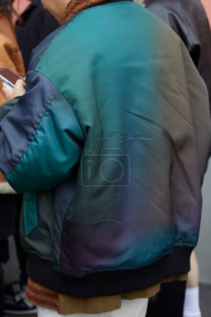 Photo for MILAN, ITALY - JANUARY 14, 2024: Man with green, grey and blue bomber jacket before K-Way fashion show, Milan Fashion Week street style - Royalty Free Image