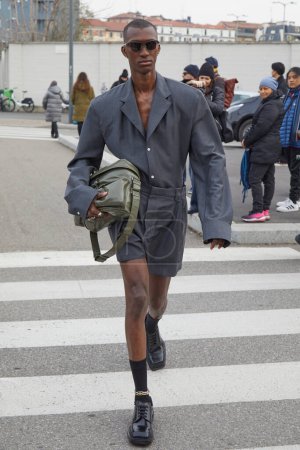 Photo for MILAN, ITALY - JANUARY 14, 2024: Man with grey jacket and shorts before Prada fashion show, Milan Fashion Week street style - Royalty Free Image