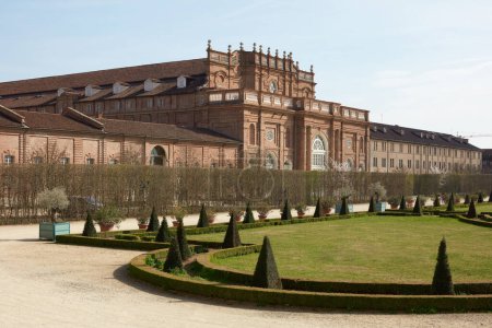 Photo for VENARIA REALE, ITALY - MARCH 29 , 2023: Reggia di Venaria castle architecture and park with pyramidal hedges in spring sunlight - Royalty Free Image