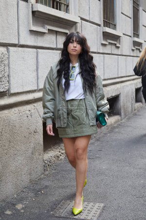 Photo for MILAN, ITALY - FEBRUARY 21 , 2024: Woman with sage green bomber jacket and skirt before Iceberg fashion show, Milan Fashion Week street style - Royalty Free Image