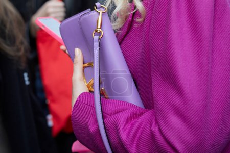 Photo for MILAN, ITALY - FEBRUARY 21 , 2024: Woman with Valentino purple leather bag and pink jacket before Marco Rambaldi fashion show, Milan Fashion Week street style - Royalty Free Image
