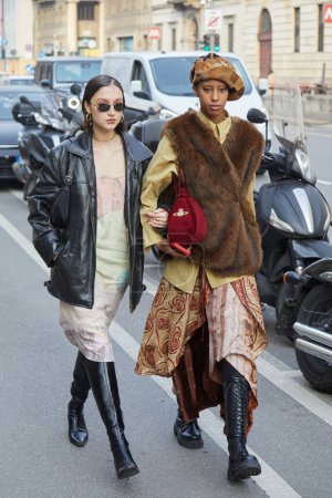 Photo for MILAN, ITALY - FEBRUARY 21 , 2024: Women with black leather jacket and brown fur coat before Marco Rambaldi fashion show, Milan Fashion Week street style - Royalty Free Image