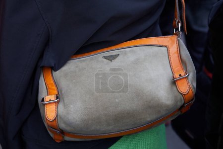 Photo for MILAN, ITALY - FEBRUARY 21 , 2024: Woman with Prada bag in grey and orange colors before Marco Rambaldi fashion show, Milan Fashion Week street style - Royalty Free Image