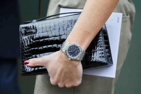 Photo for MILAN, ITALY - FEBRUARY 22 , 2024: Woman with Audemars Piguet Royal Oak watch and black crocodile bag before Max Mara fashion show, Milan Fashion Week street style - Royalty Free Image