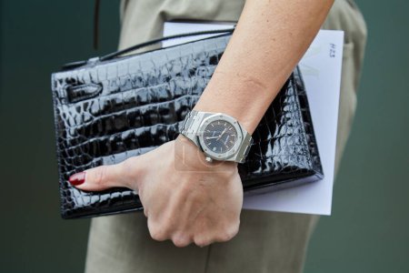 Photo for MILAN, ITALY - FEBRUARY 22 , 2024: Woman with Audemars Piguet Royal Oak watch and black crocodile bag before Max Mara fashion show, Milan Fashion Week street style - Royalty Free Image