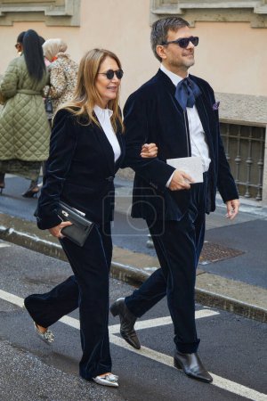 Photo for MILAN, ITALY - FEBRUARY 25 , 2024: Woman and man with blue velvet jacket and trousers before Giorgio Armani fashion show, Milan Fashion Week street style - Royalty Free Image