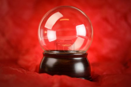 Téléchargez les photos : Boule de neige transparente ou boule de cristal vierge sur fond rouge - en image libre de droit