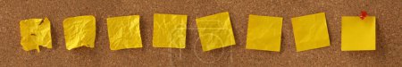 Photo for Blank yellow sticky notes on noticeboard with crumpled notes progressing to a smooth blank notice. Concept for the development or evolution of ideas. - Royalty Free Image